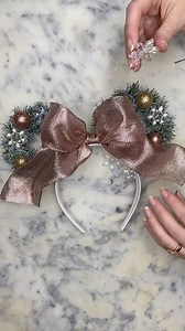 Keiko Lynn on Instagram: "Watch the video for a step by step tutorial on how to make two different Minnie inspired Christmas Wreath Ears. Then, head over to @kimblygrace’s page to see how to make two other versions. To start, gather your supplies. You will need: A garland/wreath that's made with wire so you can cut off and shape the branches to make the wreath. One headband Hot glue gun Wire cutter or scissors Whatever decorations you want to use (ornaments, bows, ribbons, flowers, fake snow, ga