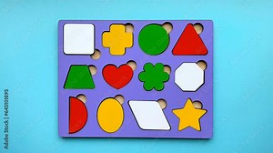 Close-up of an educational toy with inserts, with female hands demonstrating assembly and disassembly Stock Video