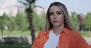 A young woman looking directly into the camera, and displaying facial expressions that convey agreement, disagreement, and listening attentively.