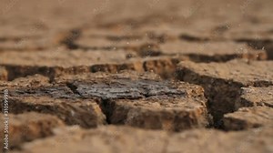 Rain water drop to dry cracked earth metaphor climate change, water crisis and environment damage from global warming concept.