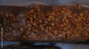 Buckwheat is cooked in a transparent glass pan. buckwheat cooking process. Cooking buckwheat in a glass container