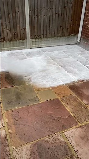 Using chemicals to help lift the black spot and rust stains on this indian sandstone patio
