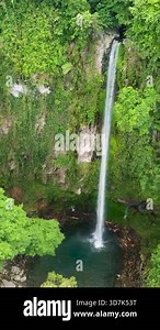 Waterfall surrounded by lush greenery forest in Katibawasan Falls. Camiguin Island. Philippines. Vertical video Stock Video Footage - Alamy