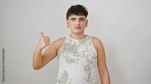 Shocked young man in a sleeveless t-shirt, pointing to the side with surprise, mouth wide open. isolated on a white backdrop - a fun, unexpected discovery!
