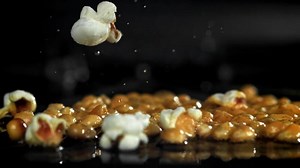 Popcorn explodes in the pan. Filmed on a high-speed camera at 1000 fps. High quality FullHD footage