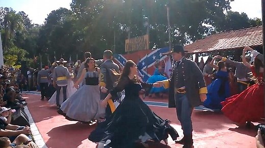 Dancers wear Southern belle attire at Festa Confederada