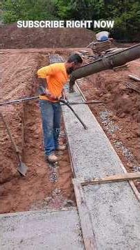 2 GUYS POUR A CONCRETE FOOTING IN THE RAIN