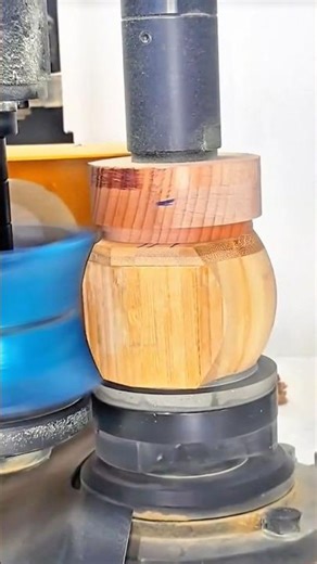 Industrial wood shaper machine turning and carving a decorative wooden sculpture