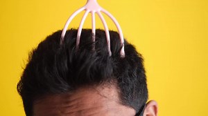 Head massager used on man