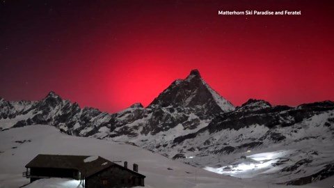 Rare aurora borealis turns sky red over Matterhorn mountain