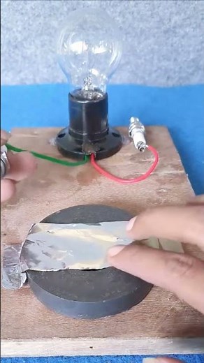creative idea to turn on a light bulb using a magnet and spark plug #lightbulb #magnet #sparkplugs