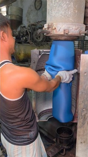 How a skilled worker manufactures large plastic drums in a factory using machines.