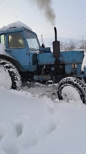 Blue Tractor Stuck in Snow: Winter Challenges