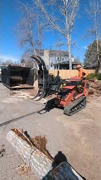 Loading a huge cottonwood log into the rolloff truck with the little ditchwitch sk1550. Fort Collins