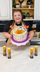 Sprinkle lovers, this cake decorating idea is for you: instead of piping, create a design with sprinkles! Sweet Kate Bakery created this fun, festive, and intricate Halloween design that's sure to impress your guests. 🎃✨ | Wilton Cake Decorating