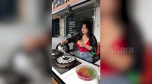 Street food cook shows off her EE cup breasts while selling coconut pancakes
