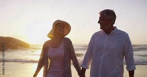 Senior couple, beach walk and hand holding in sunset and married on holiday, outdoor and retired. Retirement, elderly or love for commitment, bonding together or care for happy romantic relationship