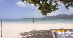 Wide Scenic View of Latino Lady Return from Swim in Sea on Tropical Beach Resort Playa Teco Maimon, gentle zoom