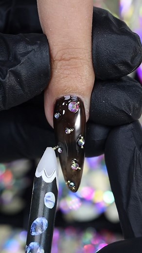 PLA Nail Gems are the simplest way to add some glitz and glam to any nail look!  Just pair with a wax pen and PLA Gel Overlay Top Coat (which come free with each Nail Gem purchase) and watch the magic happen! Products used: 214 - Lily of the Valley Gel Polish Jet Black Gel Polish Overlay Top Coat PLA Nail Gems - AB #PLANails  #PLAPro #parislashacademy #PLAGels #PLAGelLiners #nailart #nailgems | PLA Nails | Facebook