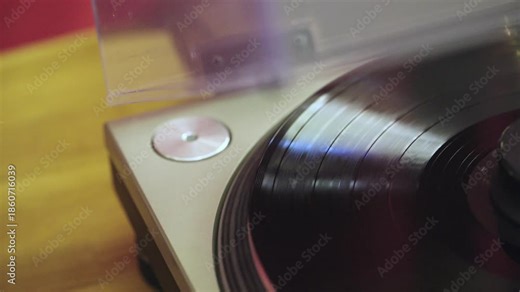 4K slow motion footage of spinning vinyl record. Retro turntable working, playing music. Close up top view shot.