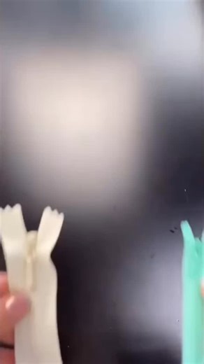 More sewing tips and tutorials on my YouTube Channel Notches Sewing In this video, I show you one method to install the slider onto the invisible zipper tape. Unlike regular zippers, the coil (teeth) is not visible on the front of the zipper when sewn into the garment. The coil is on the back side (wrong side) of the zipper tape. The Slider has two channels on either side that meet at the centre. Under the zipper pull tab, there is a point and that is where you stop when threading in the tape en