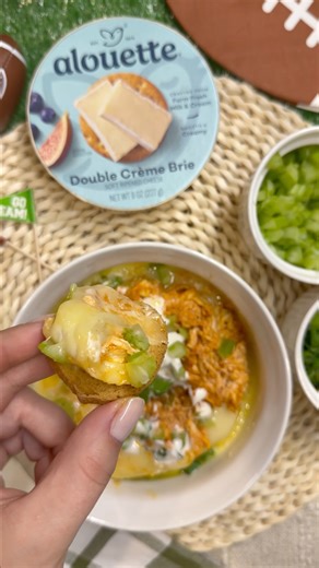 The kind of dip that disappears before halftime. Buffalo Chicken Brie alouette = Big Game energy 🏈🧀 1 round alouette Double Crème Brie 1-2 C shredded rotisserie chicken 1 C buffalo sauce 1/2 TBSP garlic powder 1/2 TBSP onion powder 1-2 TBSP ranch dressing 1 celery stalked finely diced 1 green onion stalk finely diced Instructions: 1. Preheat oven to 350 degrees 2. Combine chicken, buffalo sauce and spices in a bowl 3. Slice the rind off one side of the brie (easiest to do when the cheese is fr
