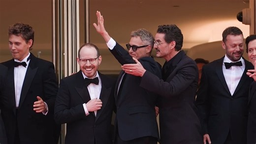 Pedro Pascal pulls Joaquin Phoenix's arm down at Cannes