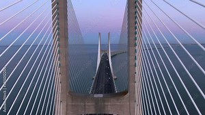 Aerial view of architectural landmark Vasco da Gama Bridge over the Tagus River at dusk in Lisbon, Portugal. The Vasco da Gama Bridge is the longest bridge in the European Union.