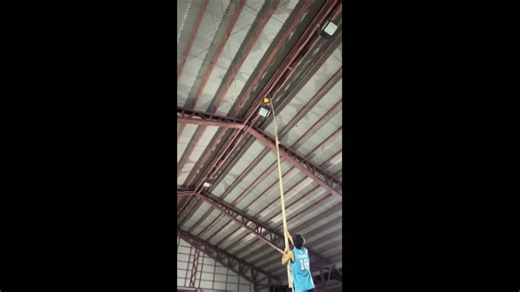 Volleyball gets stuck on covered court roof during game in Calapan, Philippines