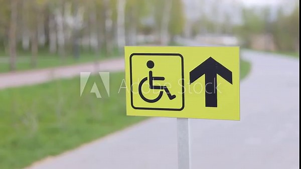 Accessible disabled sign at city park. Inclusivity, equal rights, and consideration for individuals with disabilities.