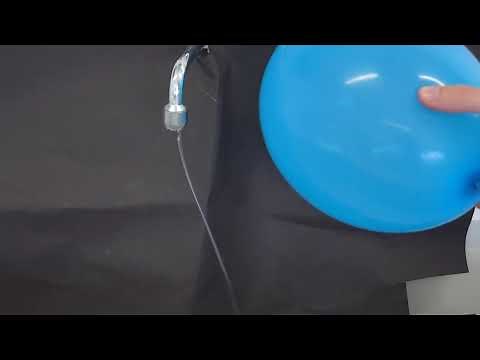 Experiment Polarization: Electrically charged balloon bends a stream of water.
