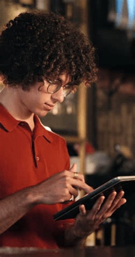 clip-4008078191-man-server-reading-tablet-pub-inventory-drinks