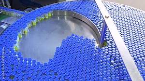 injection in glass ampoule vial moving at high speed in a healthcare pharmaceutical drug manufacturing factory. Injectable making process with latest hi tech machinery equipment