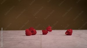 Raspberry rolling in super slow motion. high speed camera footage of raspberry rolling on the ground.