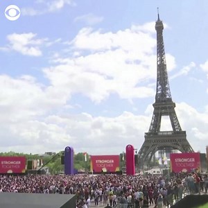 26K views · 785 reactions | PARIS 2024: Thousands waved flags and cheered in front of the Eiffel Tower on Sunday as the Olympic torch was officially passed from Tokyo to Paris ahead of the 2024 Games. | CBS News | Facebook
