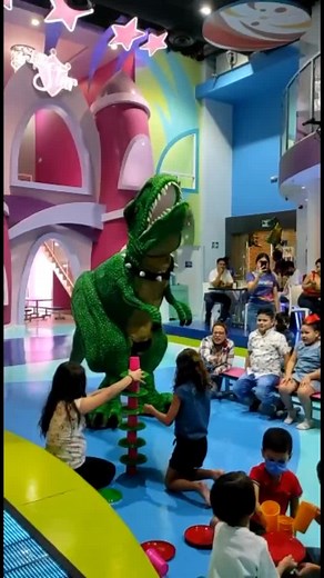 Playful Dinosaur Character Engaging with Children