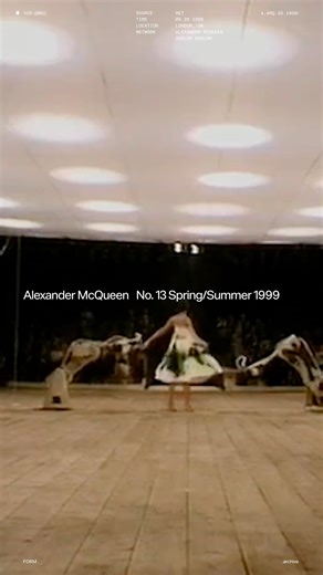 FORM on Instagram: "[.archive] At the close of Alexander McQueen’s No. 13 (Spring/Summer 1999), the show narrowed into a single, unforgettable image: Shalom Harlow, in a simple white dress, placed on a rotating platform like a music box figure brought to life, poised between elegance and exposure. Two industrial robotic arms, borrowed from a car factory, slowly “woke,” circled her, and then sprayed her dress in violent bursts of paint, turning purity into something authored by force as much as b