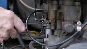Repair old car engine. The technician sets the engine to idle