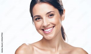 Portrait of a beautiful young woman smiling at the camera on a white background