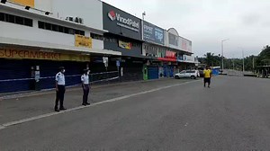 Police officers monitor the Shop 'N' Save Nabua area after it was cordoned off this morning, May 23, 2021. Video: SOPHIE RALULU #TimesNews #FijiNews #COVID19Fiji #MaskUpFiji #StayHomeSavesLife | The Fiji Times