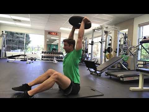 Plate Sit-up with overhead press exercise