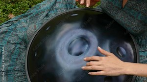 Beautiful female hands on a perfect musical percussion instrument.
