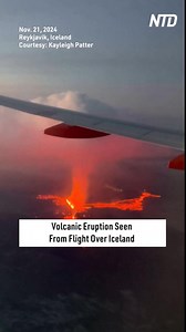 Footage captured aboard a plane bound for Keflavik Airport, southwest of Iceland's capital Reykjavik, shows a volcano erupting on Thursday (November 21). The dramatic scene showed lava flows and a towering plume of smoke rising into the sky as the plane neared the airport. | NTD Life