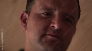 Static close up FHD shot of a man, bowing his head in sadness and desperation, contemplating his life, sadly closing his eye and pursing his lips. A sad man on the verge of crying thinking about life.