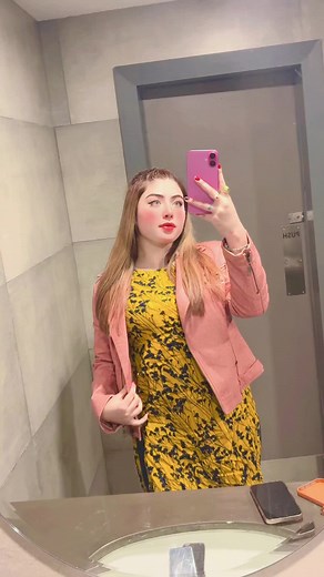 Stylish Bathroom Selfie in Pink Jacket and Floral Dress