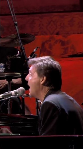 Eric and Paul McCartney performing “While My Guitar Gently Weeps” at a concert for George Harrison.