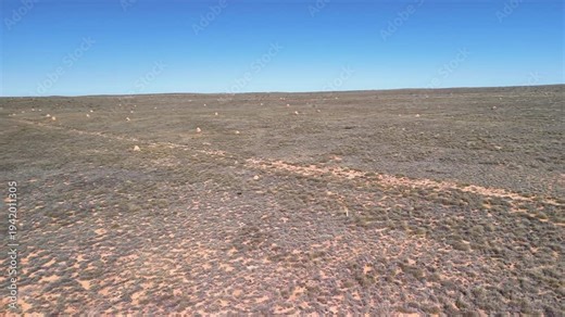 Exmouth road aerial view revealing iconic termite mounds dotting arid outback landscape Western Australia highway