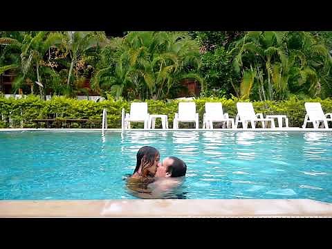 Young couple kissing in the swimming pool on their vacation. slow motion. 1920x1080
