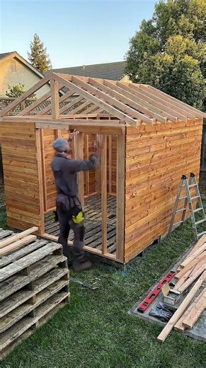 Turning old pallets into a $10,000 backyard spa cabin