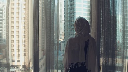 Woman Looking Out Window at Cityscape | Free Stock Video Footage